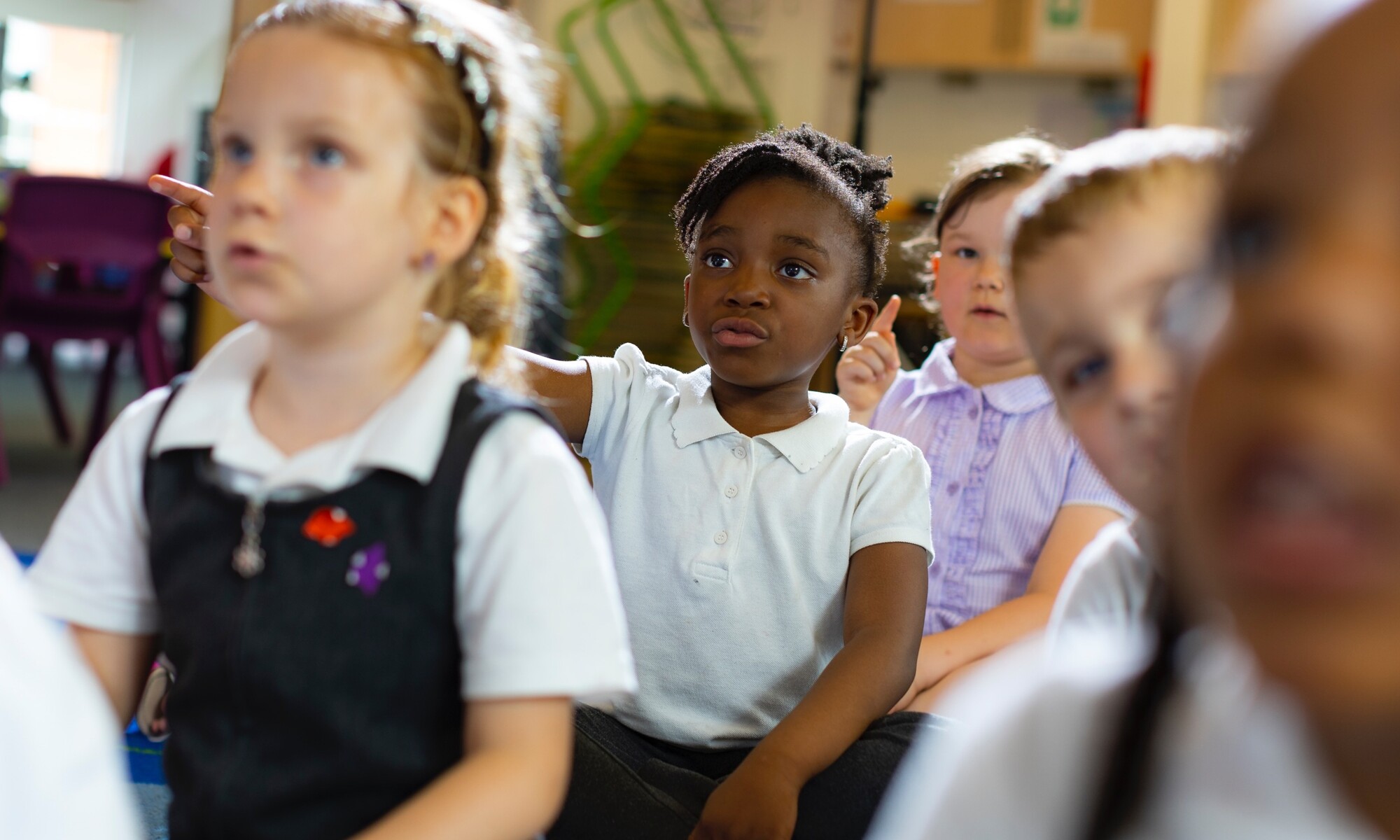 Benedict Academy Image of Pupils with their Hands Up 3